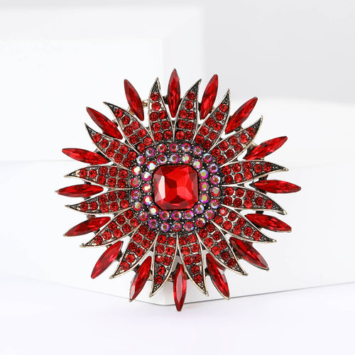 Red sunburst brooch product close-up