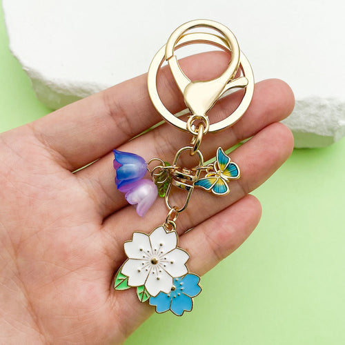 Image 2 showing a person holding two different colored flowers.
