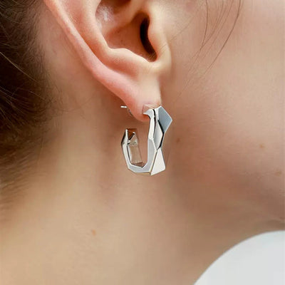 Front view of angular folded silver-tone hoops