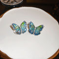 Blue Green Crystal Butterfly Stud Earrings With Polished Metal Tone Details view 1