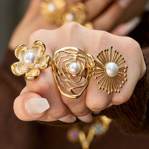 Styled hand view of pearl flower statement rings in main image 2.