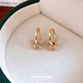 Gold Tone Flower Huggie Earrings with Crystal Petals view 2