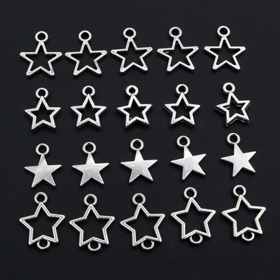 Hand held view of the small star charms showing the front shape and finish