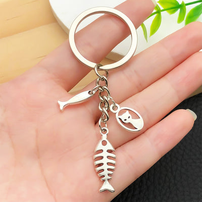 Overview showing the available color and design variations of the antique silver cat and fish bone metal keychain