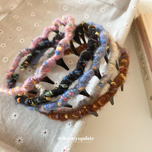 seven wrapped and plain wavy-tooth headbands in black, white, brown, and blue shown worn in a styled second view