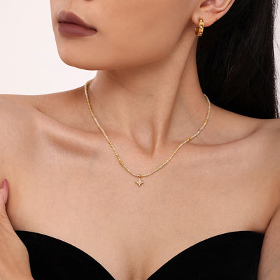 Woman wearing single natural stone bead choker with gold star pendant