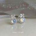 Silver Tone Bow Blue Opal Look Round Stone Halo Stud Earrings view 3