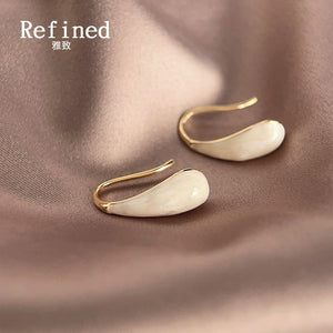 Gold-Tone Brass Hook Earrings with a Long Cream Enamel Teardrop