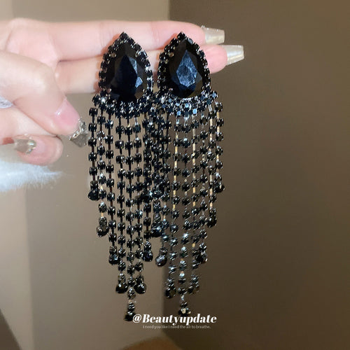 black crystal beaded waterfall fringe statement stud earrings displayed from a second angle