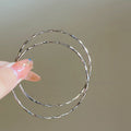 Twisted Silver Hoop Earrings in Three Sizes with Reflective Details view 7
