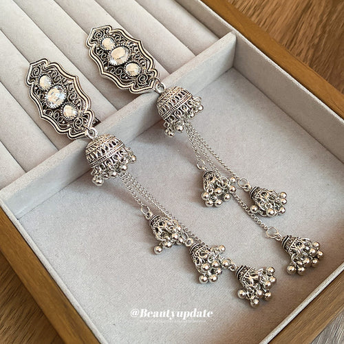 antique silver-tone ornate barrette with white stones and bell tassels shown worn in a styled second view