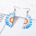 Silver Tone Daisy Acrylic Hook Earrings in Yellow and Blue view 2