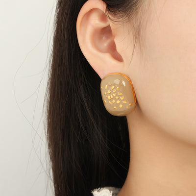 Taupe enamel square stud earring with gold flakes worn on ear