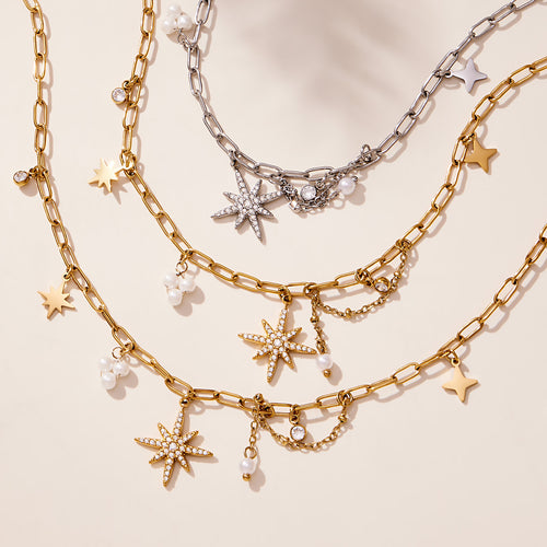 Gold and steel eight-point star paperclip necklaces with pearl charms