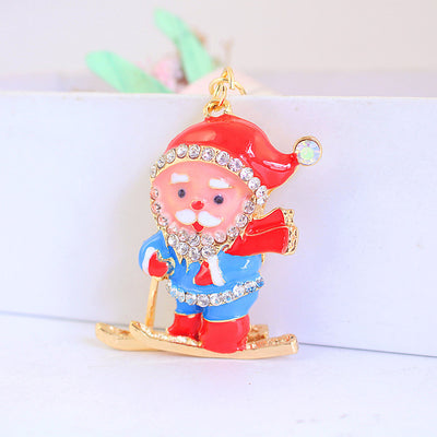 Front view of a skiing Santa charm beside a white planter.