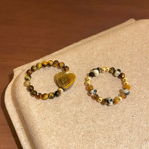 Heart tiger eye ring and mixed stone stretch ring on tray