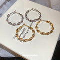 Gold Tone Twisted Hoop Earrings With Leaf Shaped Links view 4