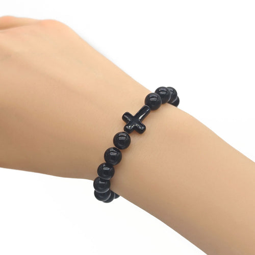 Black cross bead bracelet worn on wrist