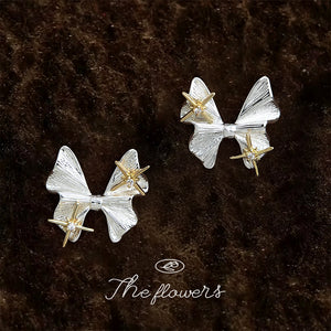 Silver Tone Bow And Gold Tone Star Accent Stud Earrings
