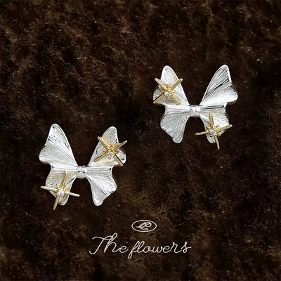 Silver-tone bow gold-tone-star-accent studs in the first product display.