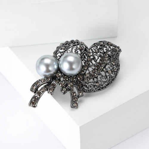 Front view of the gray crystal leaf bouquet brooch with pearls with polished metal detail on a white background