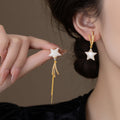 Gold Tone Asymmetric Star Earrings with Long Chain Tassels view 3