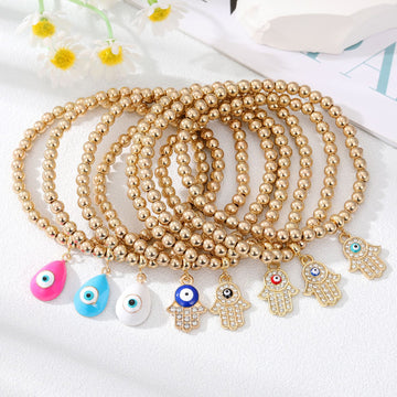 Gold Tone Beaded Evil Eye and Hamsa Charm Bracelets