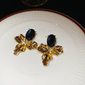 Gold Tone Oval Flower Stud Earrings with Black Centers view 1