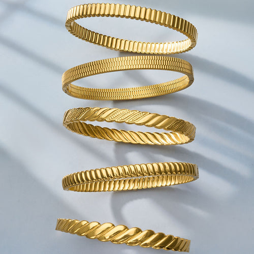 Five gold bangles arranged in spiral showing different textures
