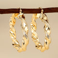 Gold Tone Twisted Open Hoop Earrings With Sculpted Texture view 1