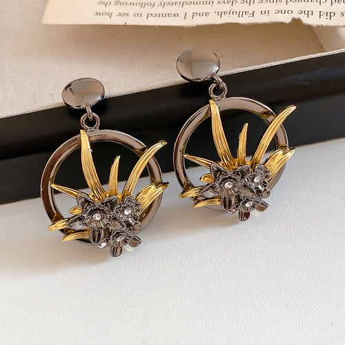 Black and Gold Openwork Floral Statement Stud Earrings shown in a display view