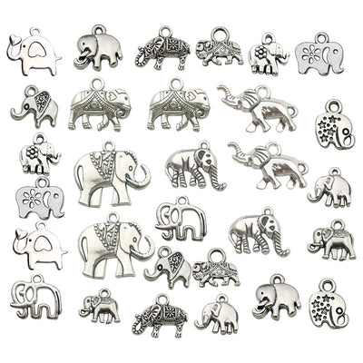 Metallic elephant charms arranged on a light background