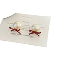 Red Bow Stud Earrings With White Pearl Drops and Gold Tone Edges view 5