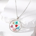 Silver Tone Round Pressed Flower Resin Necklace and Earring Options in Four Designs view 6