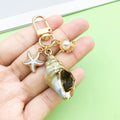 Starfish, Conch and Shell Charm Keychains Featuring Conch Across 59 Pictured Variations view 1