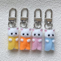 Flocked White Cat Clip Keychains in Nine Outfit Colors view 1