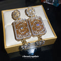 Gold Tone Crystal Rectangle Drop Earrings With Polished Metal Details view 2