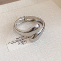 Twisted Teardrop Open Hinge Bangle Gold and Silver view 6
