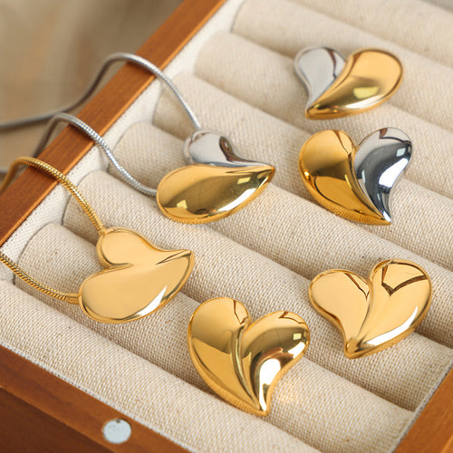 Gold and two-tone heart necklaces and studs on jewelry display
