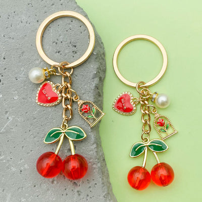 Image 1 showing two key chains with cher charms.