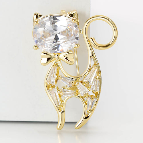 Gold crystal cat brooch close-up with oval head and bow