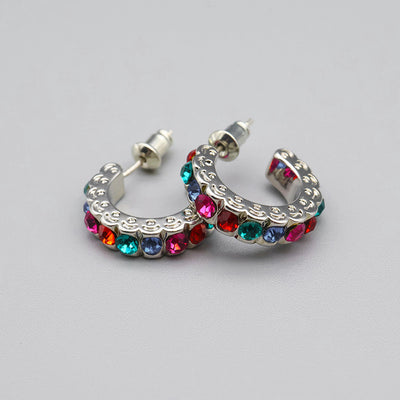 Product view showing compact silver-tone half hoops set with red, blue, green, pink, and clear stones
