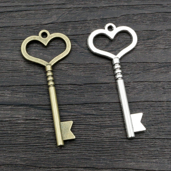 Long Heart Bow Key Pendants in Two Antique Metal Finishes