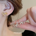 Minimal Bow Stud Earrings in Gold Tone or Silver Tone view 1
