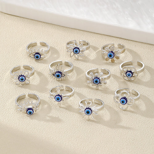 Assorted silver open rings with blue evil eye beads in flower and eye frames