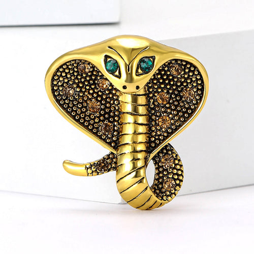 Gold cobra hood brooch champagne rhinestones green eyes front