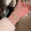White Pearl Like Double Bracelet Set With Enamel Camellia Charm view 1