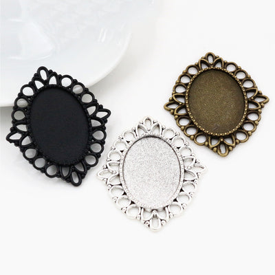 ornate oval cabochon pendant frames arranged together on a white background