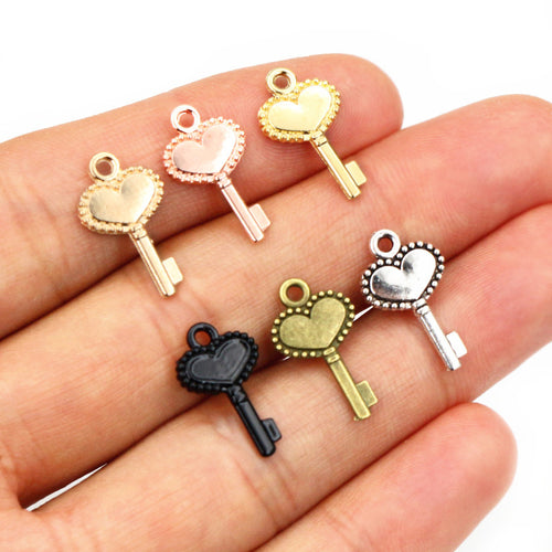 Grouped front view of heart bow key metal charms in eight finish options