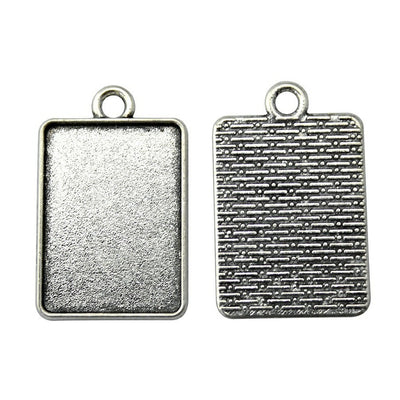 Textured Rectangular Cabochon Settings in Two Finishes held in hand for scale